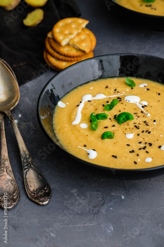Vegetable cream soup with basil, black sesame and cheese biscuits.