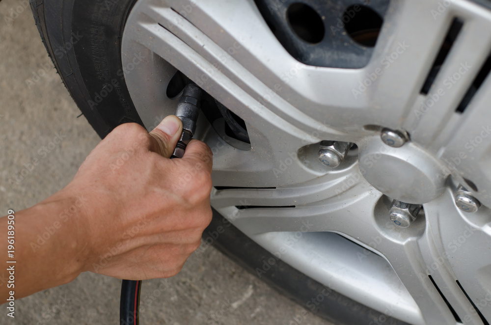 Fototapeta premium Filling air into car tire.