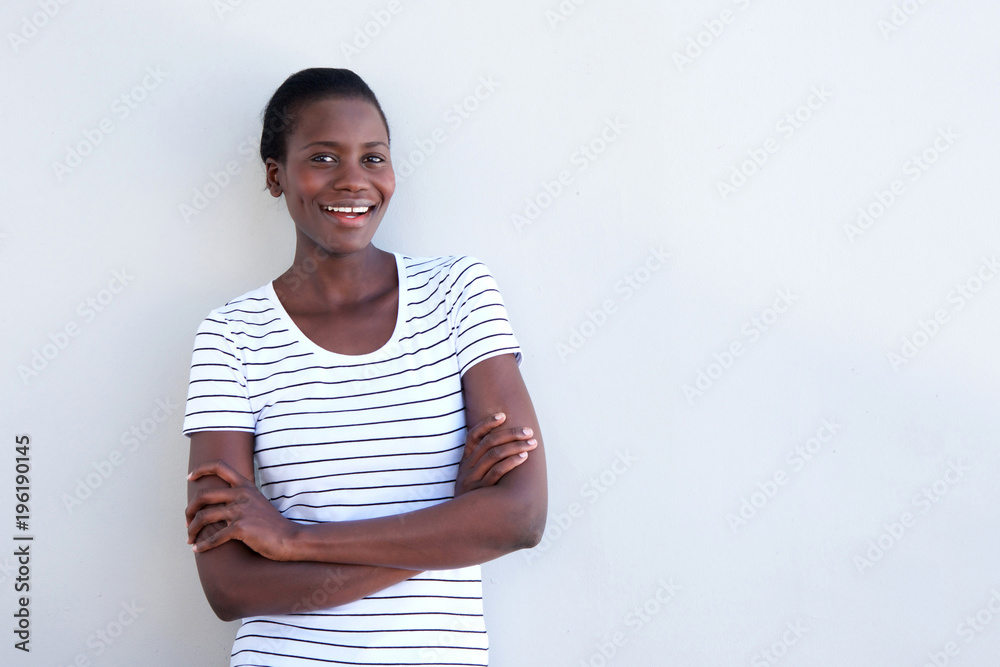 african american woman smiling with arms crossed on white background african american woman smiling with arms crossed on white background