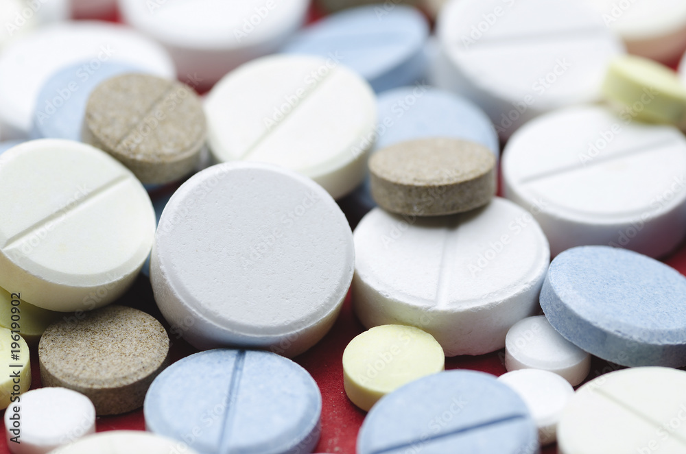 Round multi-colored tablets close-up Round multi-colored tablets close-up