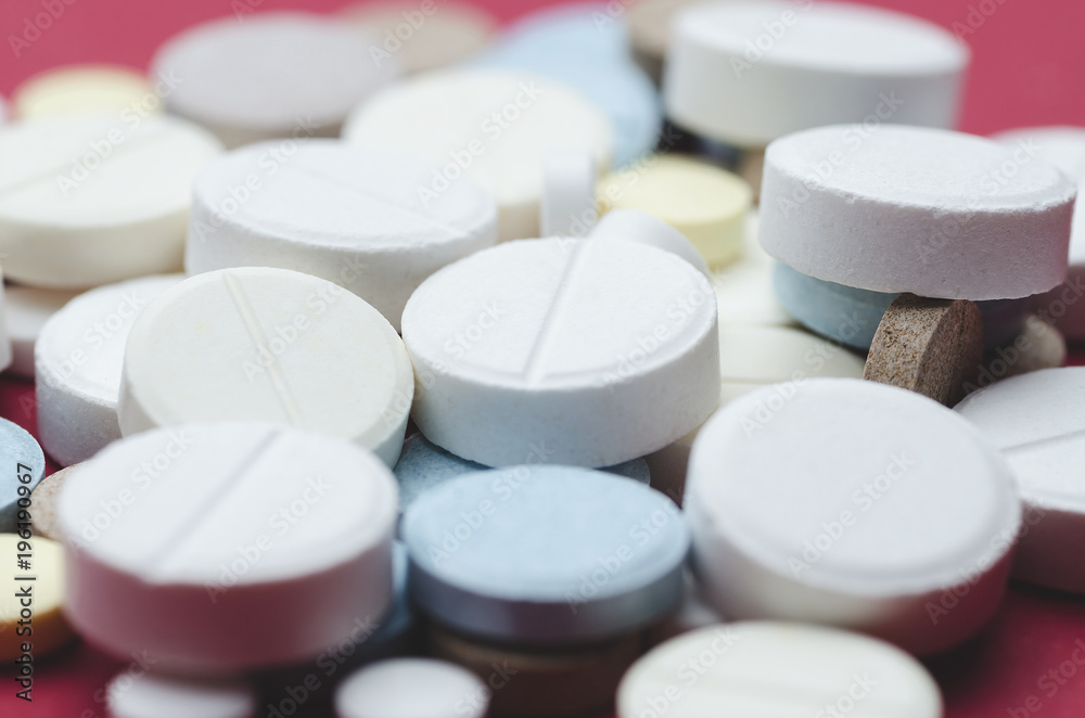 Round multi-colored pill close-up, soft focus Round multi-colored pill close-up, soft focus
