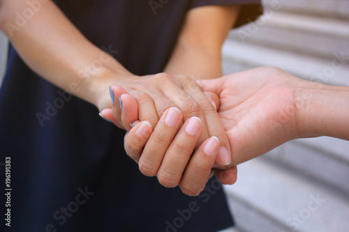 Fototapeta Naklejka Na Ścianę i Meble -  Best Friends, Two woman holding their hands