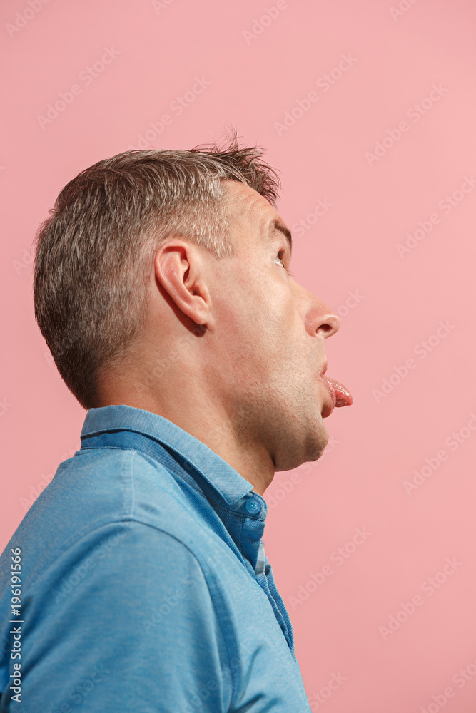 The squint eyed man with weird expression isolated on pink The squint eyed man with weird expression isolated on pink