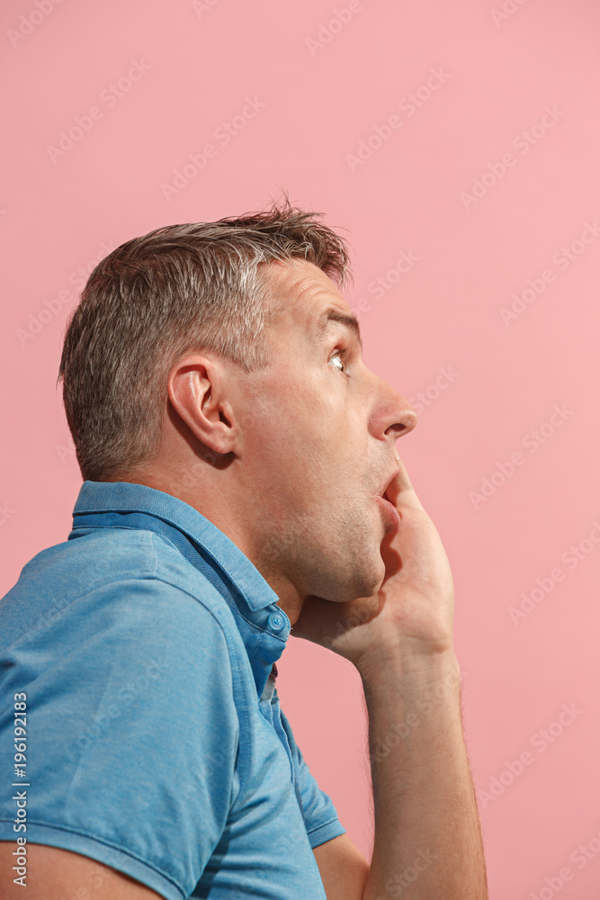 The young attractive man looking suprised isolated on pink The young attractive man looking suprised isolated on pink
