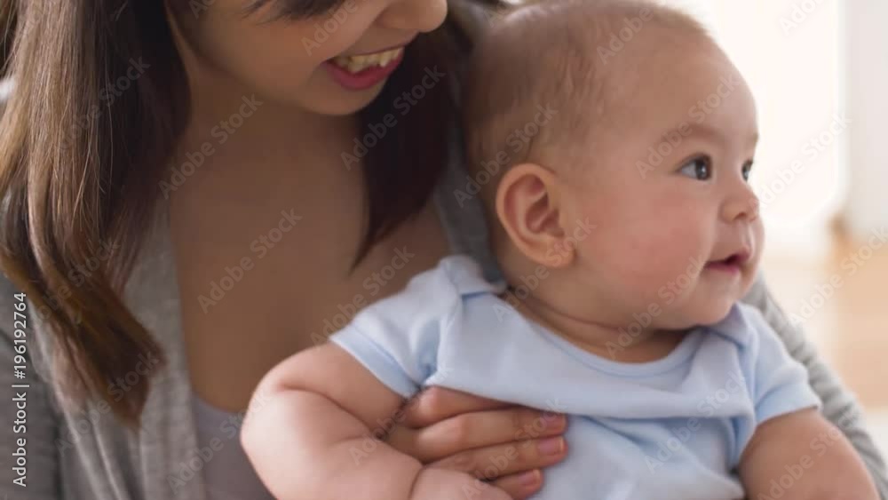 happy young mother kissing little baby at home happy young mother kissing little baby at home