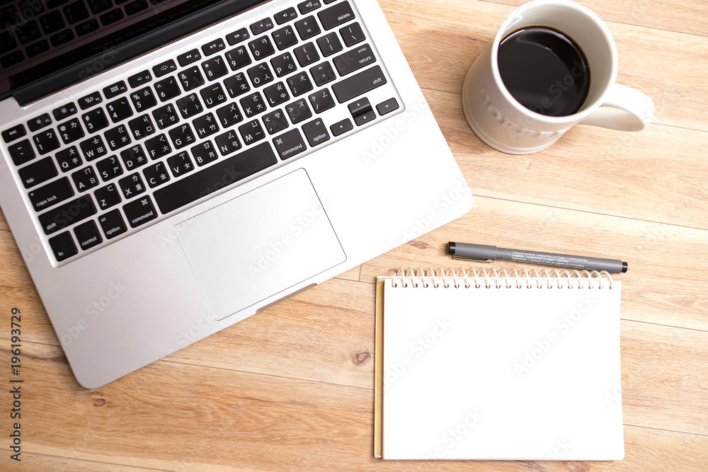 Laptop ,notebook ,pen and coffee on wood table Laptop ,notebook ,pen and coffee on wood table