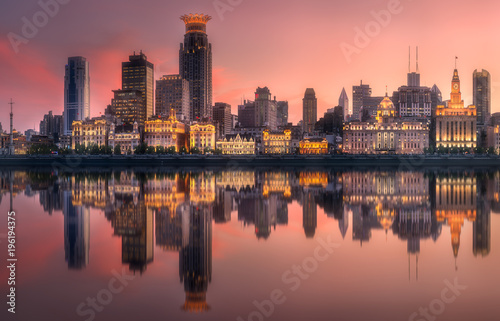 Shanghai skyline with reflection of sun on water