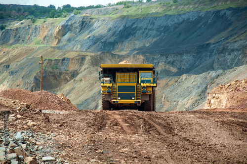 the dump truck transports iron ore. Colorful quarry. photo