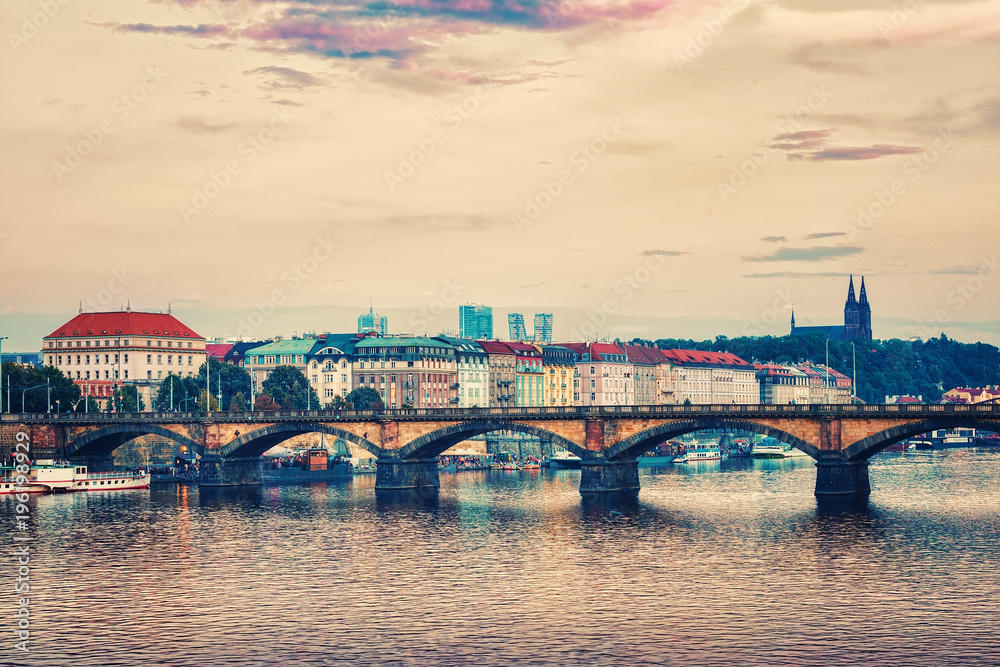 City of Prague in the summer. Panoramic view of the Vltava river, bridge and embankment in the historic center. Czech Republic. Toned.