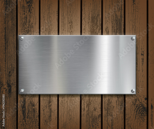 Metal plate on a wooden background.
