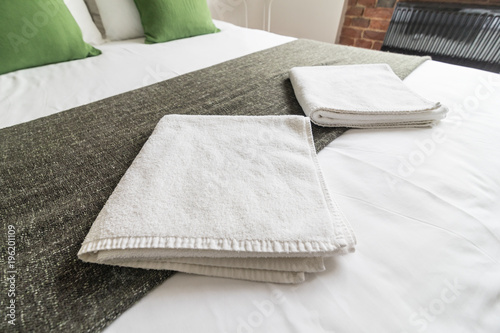 Clean towels on bed at hotel photo