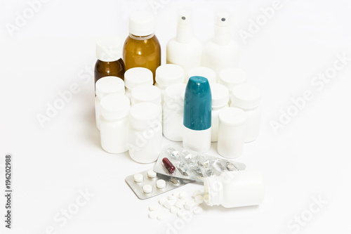 group of pills, medicine bottles, spray and syrups on a white background 