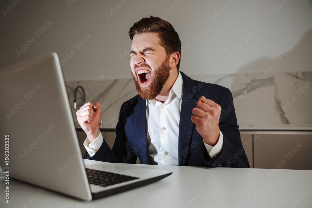 Portrait of a happy young businessman dressed in suit