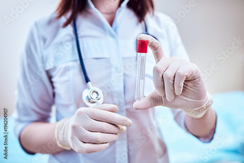 Doctor with a test tube, patient analysis.