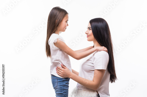 Closeup portrait of mother and daughter hugging in white background