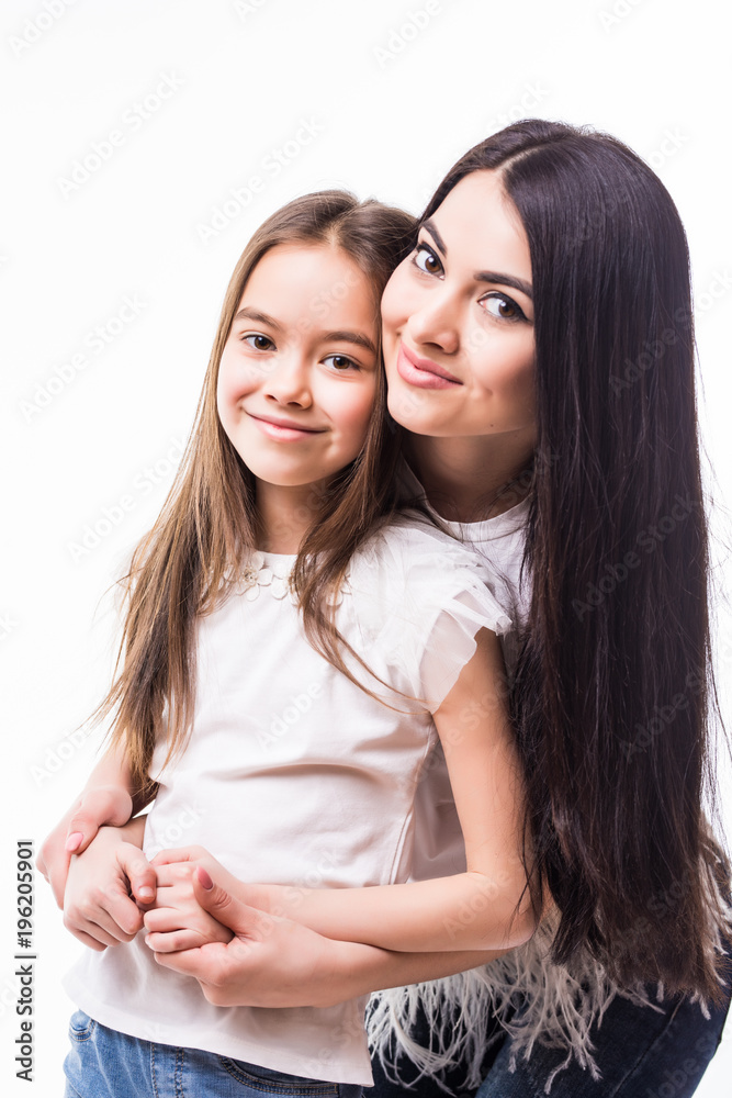 Close-up portrait of smiling mother hugging cute little daughter isolated on white background Close-up portrait of smiling mother hugging cute little daughter isolated on white background