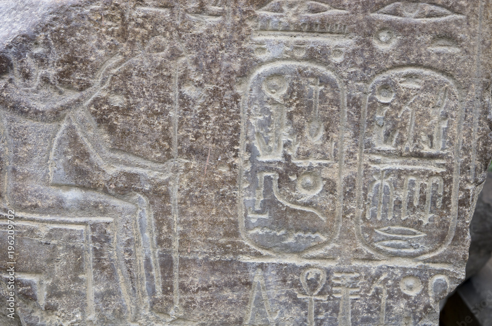 Ancient Egyptian hieroglyphs embossed in stone