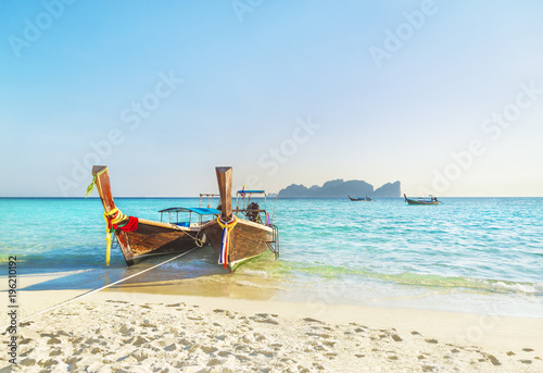 Two traditional thai longtail boats at famous sunset Long Beach, Thailand, Koh Phi Phi Don island, Krabi province, Andaman sea © EMrpize