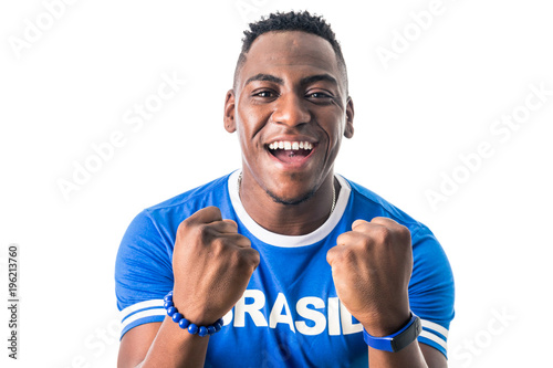 Brazilian man fan celebrating on footbal match on white background. Brazil colors. photo