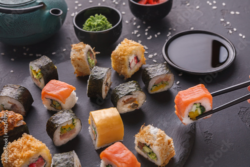 Set of sushi maki and rolls on gray background