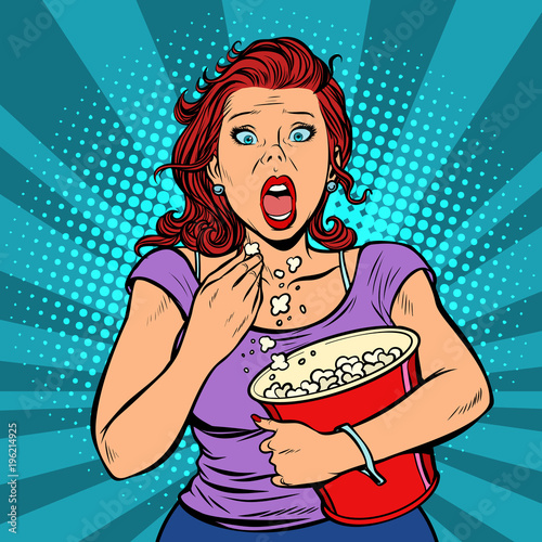 Woman watching a scary movie and eating popcorn