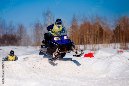 Snowmobile. Snowmobile races in snow. Concept team of friends chasing mountains.