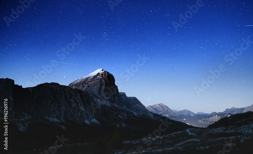 Cortina d'Ampezzo, passo Falzarego, Dolomite Alps in Italy, picturesque night landscape of star sky and mountain peaks of Alps.