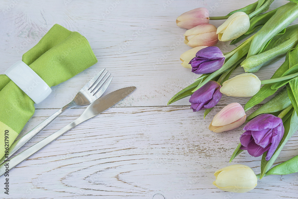 Festive table setting with bouquet of fresh tulips Festive table setting with bouquet of fresh tulips