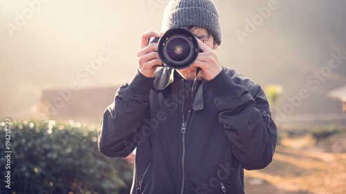 Man is a photographer with dslr camera, outdoor and sunlight, Portrait, copy space.