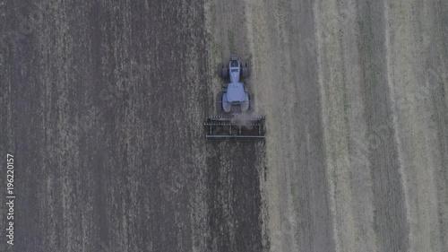 The combine removes the mote that has remained after mowing. A beautiful pattern on the ground after cutting the glass. View from above. Aerial view. 4k Video photo