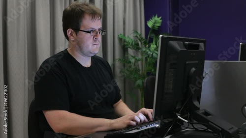 Man working in computer lab late at night.
 photo