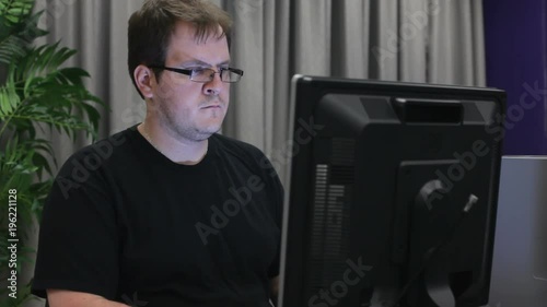 Man with late night shift programming at computer.
 photo