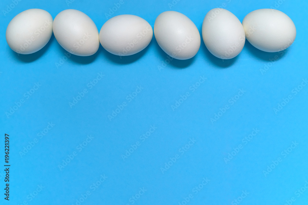 White eggs on blue background, copy space. Healthy food concept. Top view, flat lay. Easter eggs. Happy Easter concept