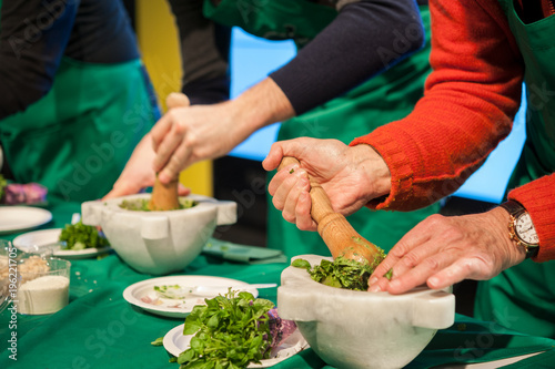 People during the preparation of the Pesto basil sauce