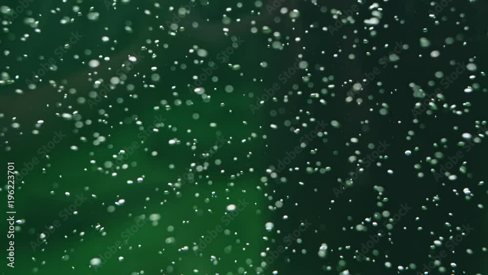 Oxygen bubbles floating in water - green bubble background Oxygen bubbles floating in water - green bubble background