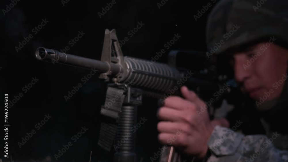 Young military soldier shooting gun