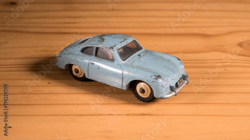 Old retro metal toy car on wooden table 
