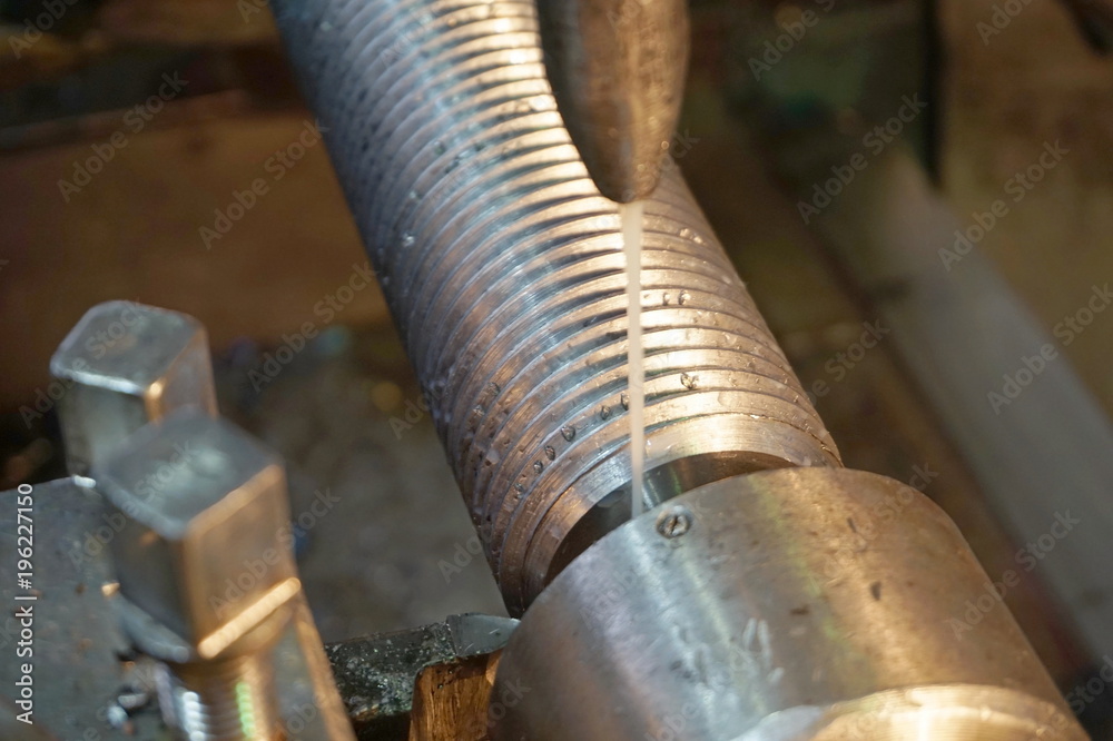 threading the shaft on the machine, a mechanical cutter threading the shaft on the machine, a mechanical cutter