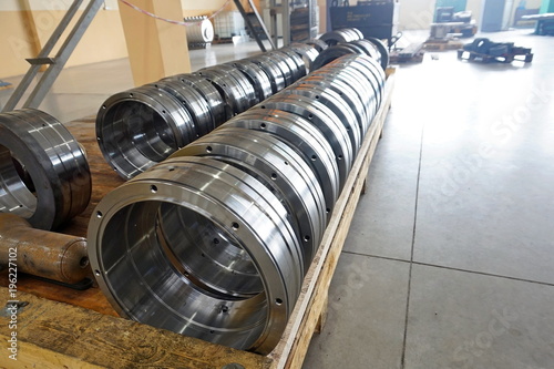 cylindrical metal parts after processing on the rack
