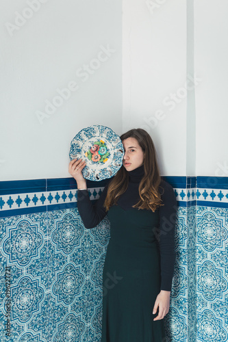 Woman standing with colorful plat photo