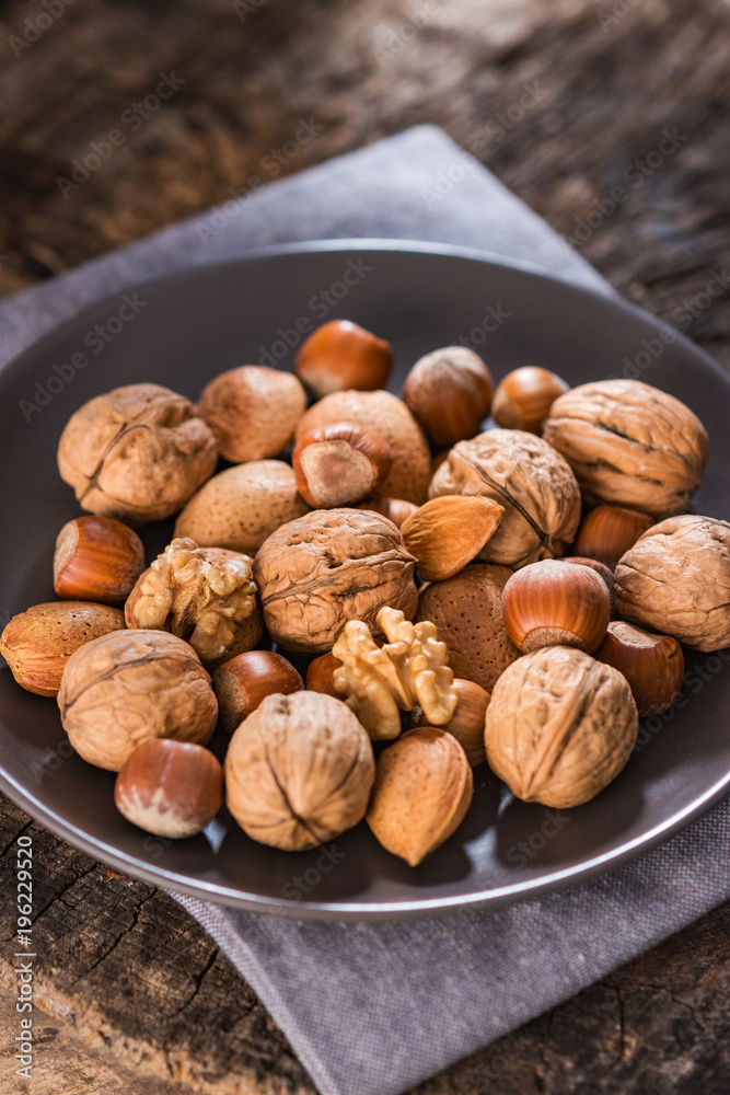 Mixed Nuts on Rustic Wooden Table Mixed Nuts on Rustic Wooden Table