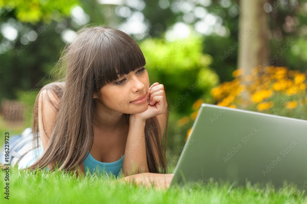 Portrait of a Young Woman Using Laptop in a Park Portrait of a Young Woman Using Laptop in a Park