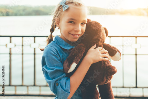 Girl embracing a cute teddy bear