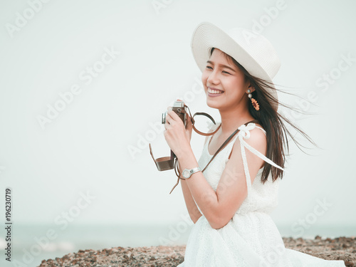 Asian woman with vintage camera
