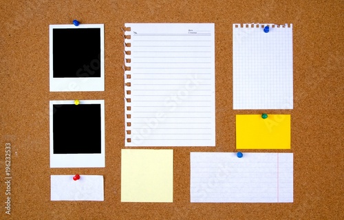 Bulletin board with with blank notes and photographs