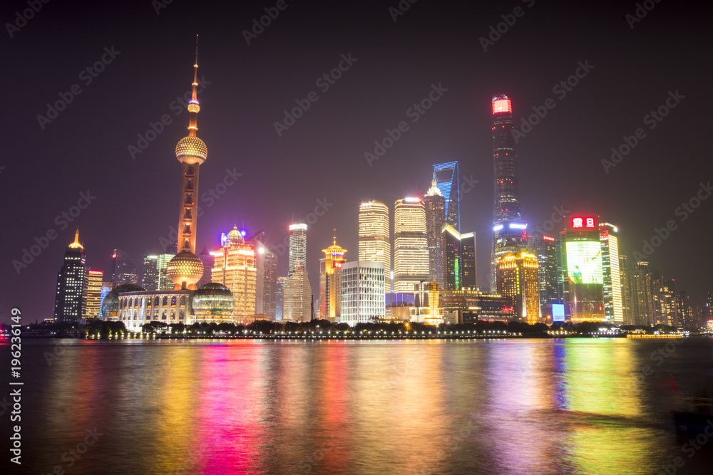The lights of Shanghai, China reflect off the Huangpu River in a Downtown area known as The Bund.