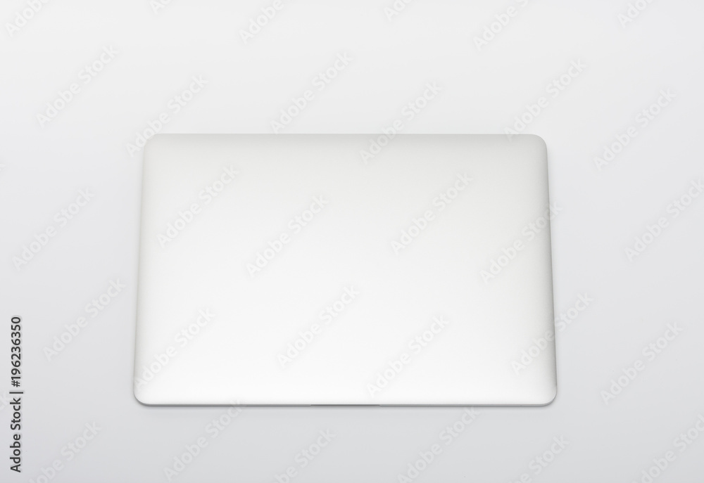 Closed modern, new laptop on white background, top view. Closed modern, new laptop on white background, top view.