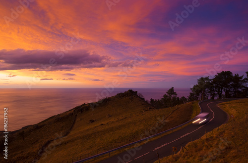 Car on mountain road at sunset, Mount Jaizkibel, Basque Country