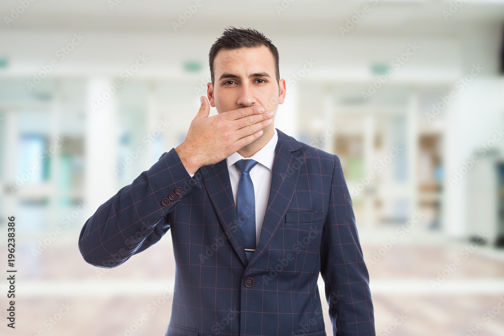 Salesman realtor or real estate agent covering his mouth. Salesman realtor or real estate agent covering his mouth.