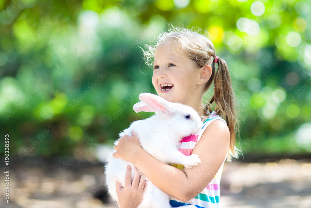 Child with rabbit. Easter bunny. Kids and pets. Child with rabbit. Easter bunny. Kids and pets.